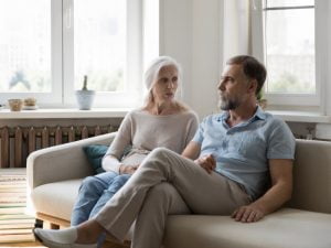 Couple have serious discussion on couch